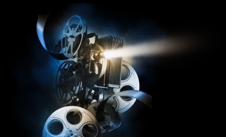 Cinema,Background,With,Movie,Projector,And,Film,Reels,On,A