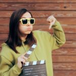 Unhappy,Actress,Holding,Film,Slate,Making,Thumbs,Down,Gesture.,Movie