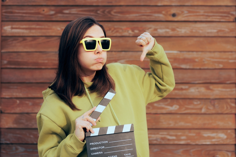 Unhappy,Actress,Holding,Film,Slate,Making,Thumbs,Down,Gesture.,Movie